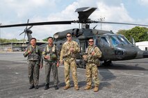 Philippine Air Force Sgt. Julius Chun Manasan, left, mechanic assigned to the 205th Tactical Helicopter Wing; U.S. Army 1st Sgt. Christopher Pacheco, center left, senior mechanic and standardization instructor assigned to the Hawaii Army National Guard; Philippine Air Force Lt. Col. John Paul Delgado, center, commander of the 210th Tactical Training Squadron; and U.S. Army Maj. John Worthington, right, Army Aviation Support Facility commander, standardization pilot and instrument examiner assigned to the Hawaii Army National Guard, pose for a photo in front of a Philippine Air Force S-70i Black Hawk helicopter during a Rotary Wing Subject Matter Expert Exchange Clark Air Base, Philippines, April 15, 2026.