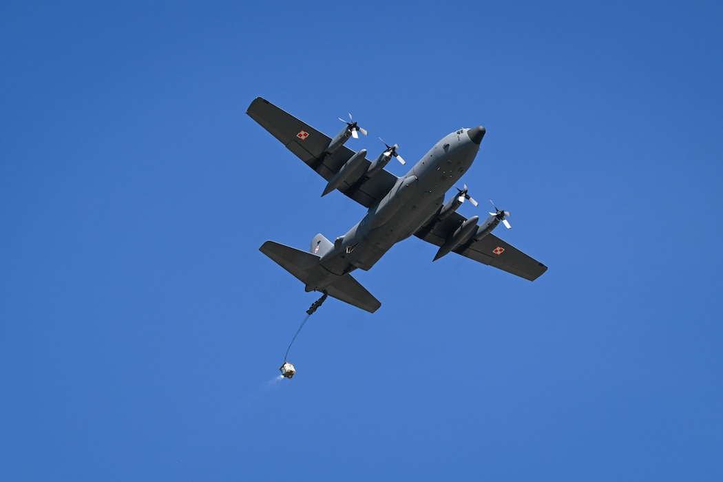 A Polish C-130H Hercules aircraft drops cargo during Rodeo Day in support of Hussar Saber 26-1.