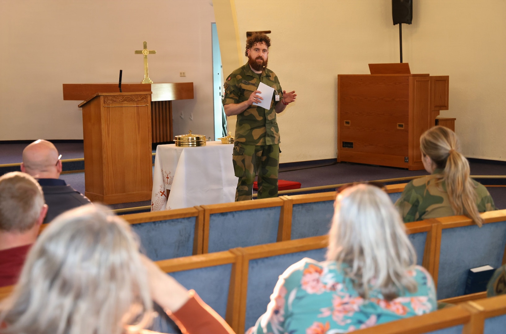 1Lt. Ida Weltzien, chaplain (l), in the Norwegian Navy and MAJ Joachim Haaland (r), chaplain, Møre og Fjordane 11th Home Guard, distributing communion elements during a non-denominational service at the Landstuhl Regional Medical Center chapel, April 29.