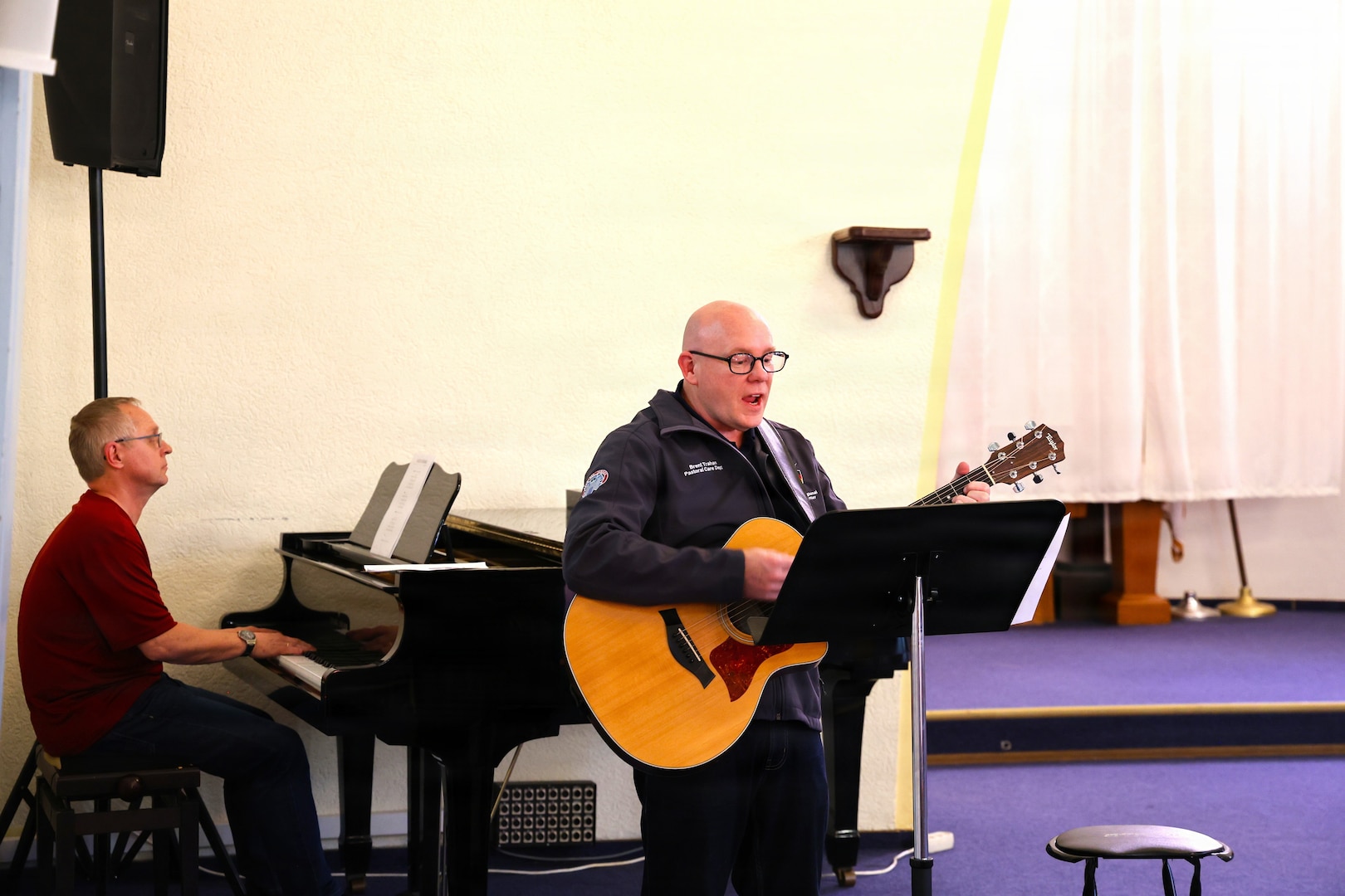 1Lt. Ida Weltzien, chaplain (l), in the Norwegian Navy and MAJ Joachim Haaland (r), chaplain, Møre og Fjordane 11th Home Guard, distributing communion elements during a non-denominational service at the Landstuhl Regional Medical Center chapel, April 29.