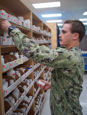 Hospital Corpsman 2nd Class Matthew R. Giunta, a pharmacy technician, inventories and restocks medications while conducting routine shelf checks at the U.S. Naval Hospital Guam pharmacy. Giunta’s efforts ensure adequate medication supply levels, preventing delays in patient care and supporting operational readiness across the command. Giunta is a member of USNH Guam's pharmacy team, which was recognized as the U.S. Navy Pharmacy Team of the Year for fiscal year 2025. The award was announced during a ceremony at the Joint Federal Pharmacy Seminar Nov. 1, 2025 and recognizes the team’s outstanding contributions to operational readiness, patient care, and process improvement, solidifying their role as a cornerstone of pharmaceutical support in the Indo-Pacific Command (INDOPACOM) area of responsibility.