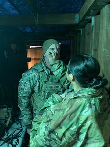 Chief Warrant Officer 2 Jack Androski, Fire Effects Cell chief, 81st Mobile Brigade Combat Team, gets camouflage face paint applied during Exercise Courage Lethality 2026 at Joint Base Lewis-McChord, Washington, April 9, 2026.