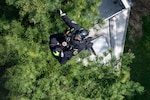A technician from the Maryland Helicopter Aquatic Response Team and a member of the Maryland Air National Guard Student Flight are hoisted by a Maryland Army National Guard UH-60 Black Hawk during a Maryland Emergency Management Search-and-Rescue Exercise at Gunpowder Falls State Park, Maryland, April 23, 2026. State agencies, local jurisdictions and non-governmental organizations gathered in Baltimore County to test their skills through a series of immersive scenarios during the 12-hour operational period. Photo by Senior Airman Sarah Hoover.