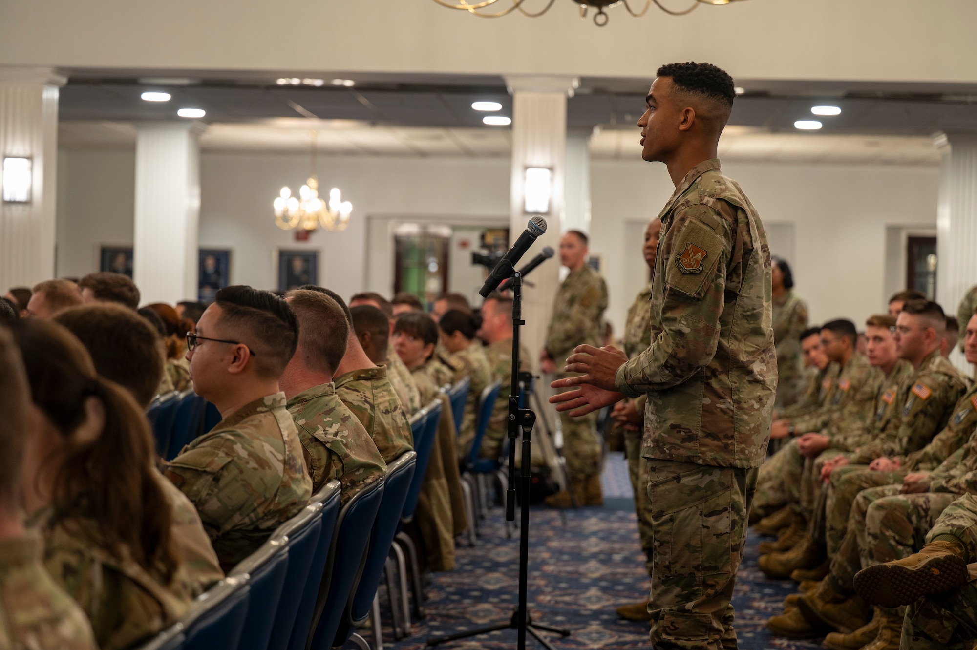 U.S. Air Force Airman 1st Class Pierce Leverette, ceremonial guardsman for the U.S. Air Force Honor Guard, asks a question during an All Call with U.S. Air Force Chief Master Sergeant of the Air Force David R. Wolfe at Joint Base Anacostia-Bolling, Washington, D.C., on May 6, 2026. During the call, the floor was opened for Airmen to ask questions about the evolving mission and priorities of the force. (U.S. Air Force photo by Senior Airman Shanel Toussaint)