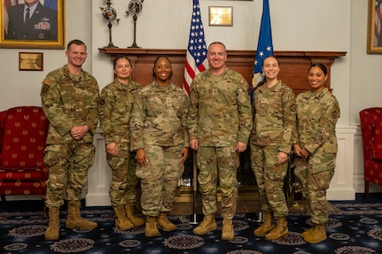 U.S. Air Force coin recipients gather with Chief Master Sergeant of the Air Force David R. Wolfe after a coin ceremony at Joint Base Anacostia-Bolling, Washington, D.C., on May 6, 2026. Wolfe recognized the Airmen for their achievements and volunteer efforts during their time in the force. (U.S. Air Force photo by Senior Airman Shanel Toussaint)