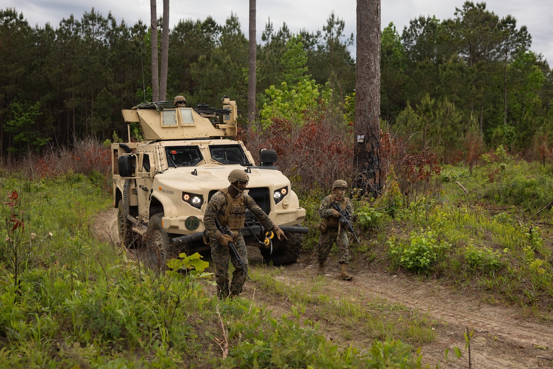 U.S. Marine Corps Sgt. Ishmael Taylor, left, a logistics specialist, and 2nd Lt. Anthony Lindgren, a basic logistics officer, both with Combat Logistics Battalion 2, Combat Logistics Regiment 2, 2nd Marine Logistics Group, walk towards a Humvee during improvised explosive device training as part of a field exercise at Marine Corps Base Camp Lejeune, North Carolina, April 30, 2026. CLB-2 conducted the exercise to complete training and readiness requirements, sustain company competencies, and enhance operational readiness in support of future mission requirements. Taylor is a native of Maryland. Lindgren is a native of Pennsylvania. (U.S. Marine Corps photo by Sgt. Rafael Brambila-Pelayo)