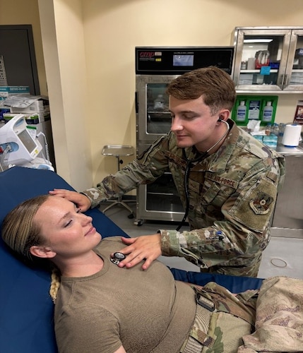 Image of an Airman treating a patient.