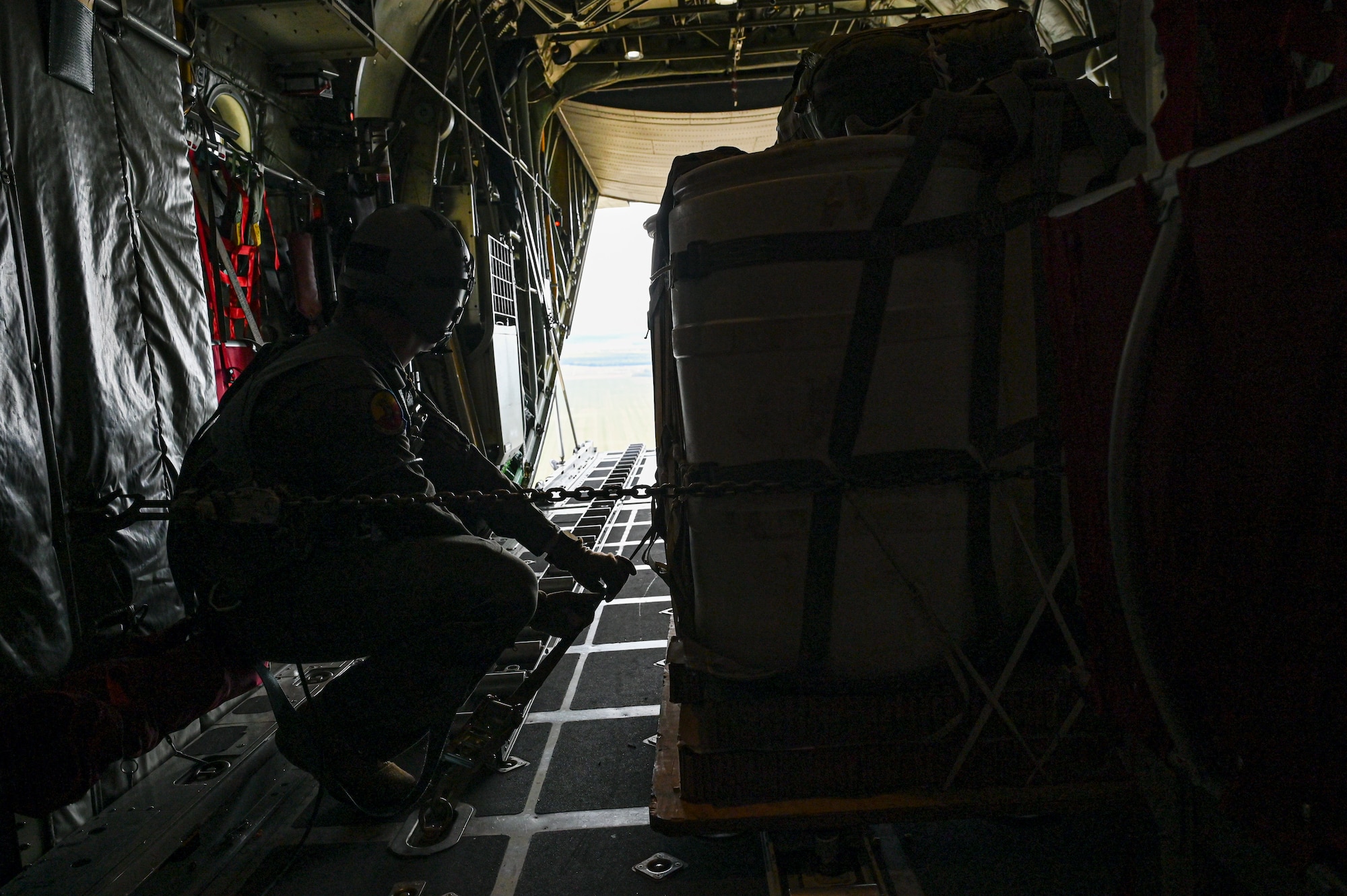 U.S. Air Force Senior Airman Gavin Clark, 180th Airlift Squadron loadmaster, prepares to drop cargo from a C-130H Hercules aircraft assigned to the 139th Airlift Wing, during Hussar Saber 26-1.