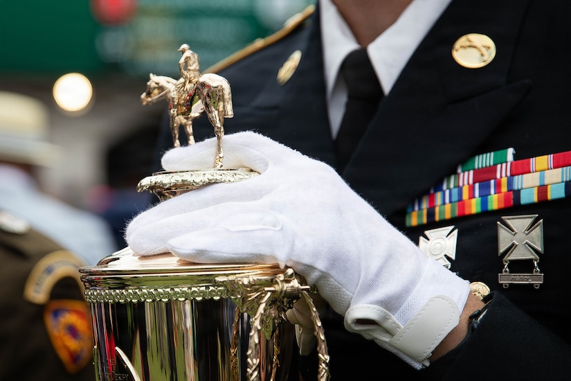 Staff Sgt. Jonathan Miller of the 617th Military Police Company escort the winner's trophy onto the Paddock at the 152nd running of the Kentucky Derby at Churchill Downs in Louisville, Kentucky, May 2, 2026.