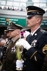 Spc. Brendan Hays and Staff Sgt. Jonathan Miller of the 617th Military Police Company escort the winner's trophy onto the Paddock at the 152nd running of the Kentucky Derby at Churchill Downs in Louisville, Kentucky, May 2, 2026.