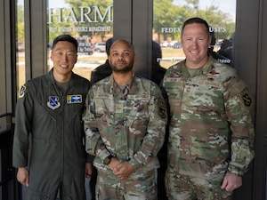 U.S. Air Force Col. Jun S. Oh, 316th Wing and installation commander, and Chief Master Sgt. Kevin Helms, 316th Wing command chief, recognize  Senior Airman Cody L. Henrico, a host aviation resource management journeyman assigned to the 316th Operations Support Squadron, for his accomplishments during a leadership visit at Joint Base Andrews, Maryland, May 5, 2026.
