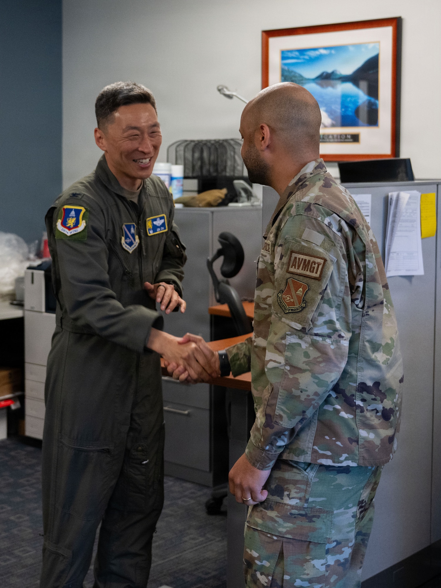 U.S. Air Force Col. Jun S. Oh, 316th Wing and installation commander, coins Senior Airman Cody L. Henrico, a host aviation resource management journeyman assigned to the 316th Operations Support Squadron, during a “Winnin’ Like a Griffin” leadership visit at Joint Base Andrews, Maryland, May 5, 2026.