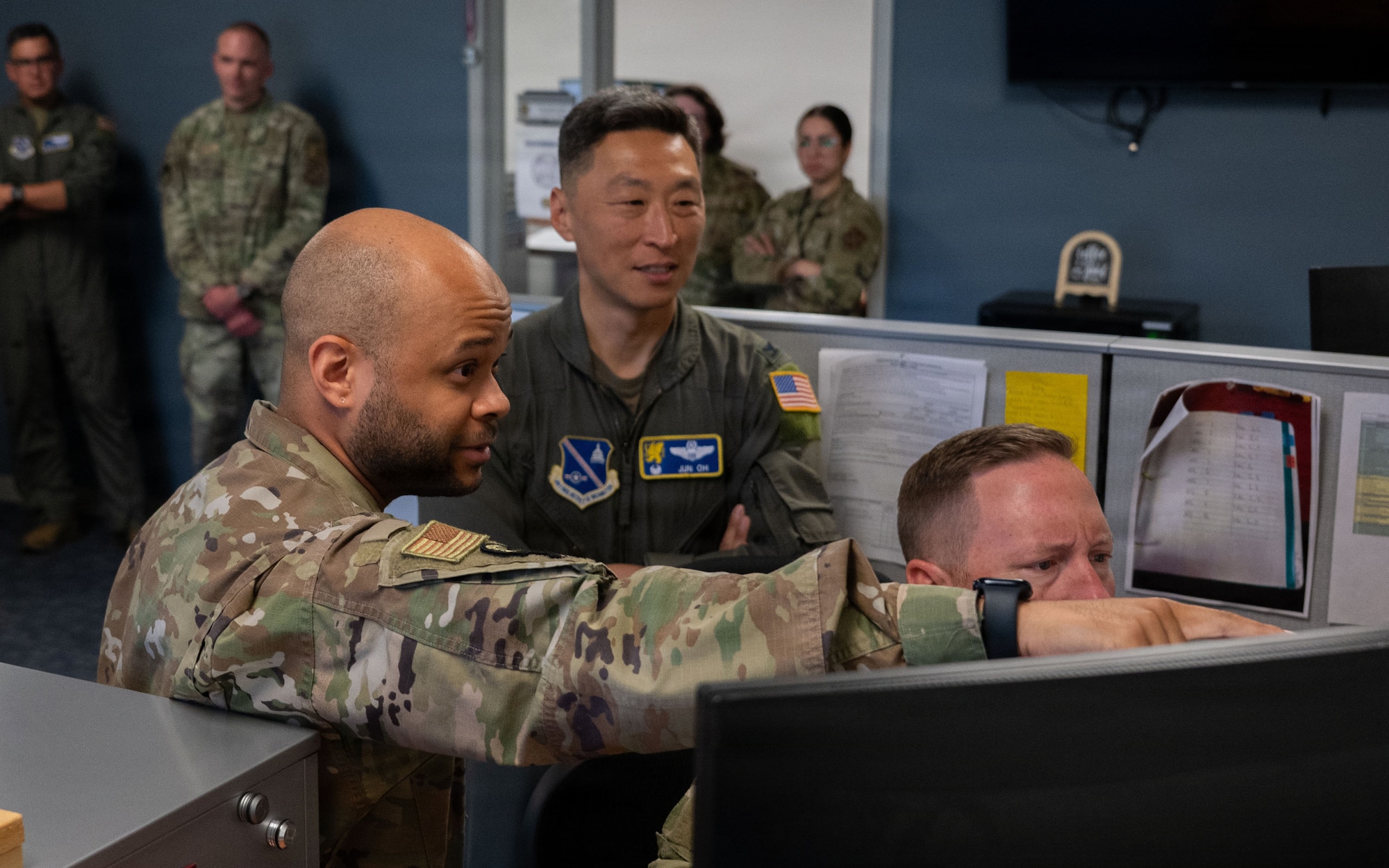 U.S. Air Force Senior Airman Cody L. Henrico, a host aviation resource management journeyman assigned to the 316th Operations Support Squadron, guides Col. Jun S. Oh, 316th Wing and installation commander, and  Chief Master Sgt. Kevin Helms, 316th Wing command chief, through his daily operations during a “Winnin’ Like a Griffin” leadership visit at Joint Base Andrews, Maryland, May 5, 2026.