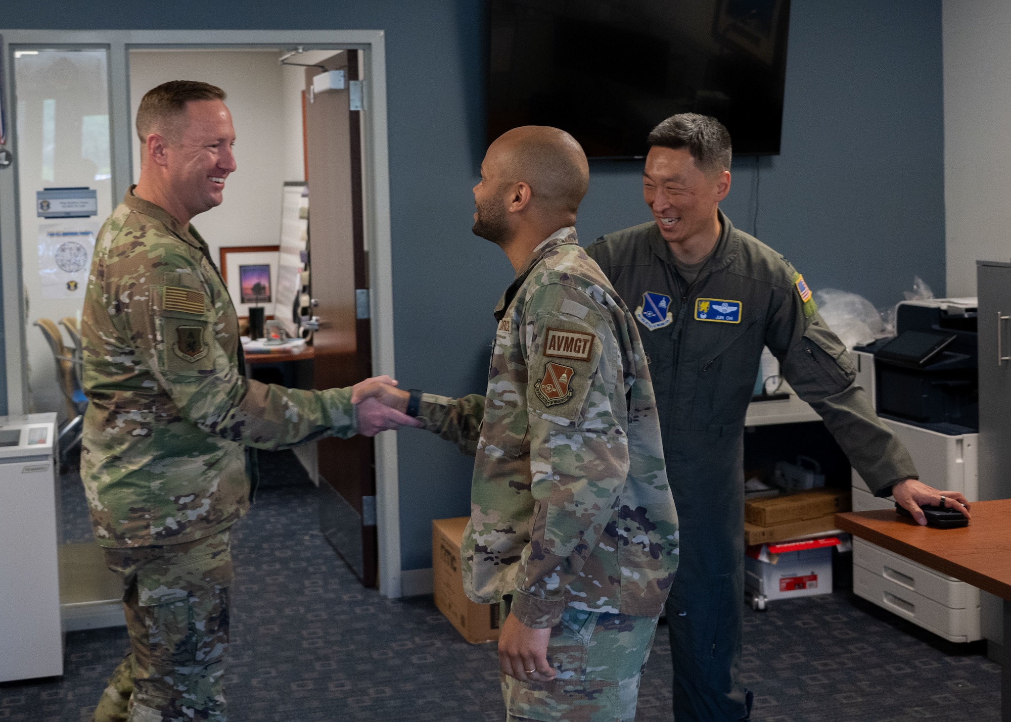 U.S. Air Force Col. Jun S. Oh, 316th Wing and installation commander, and Chief Master Sgt. Kevin Helms, 316th Wing command chief, greet Senior Airman Cody L. Henrico, a host aviation resource management journeyman assigned to the 316th Operations Support Squadron, during a “Winnin’ Like a Griffin” leadership visit at Joint Base Andrews, Maryland, May 5, 2026.