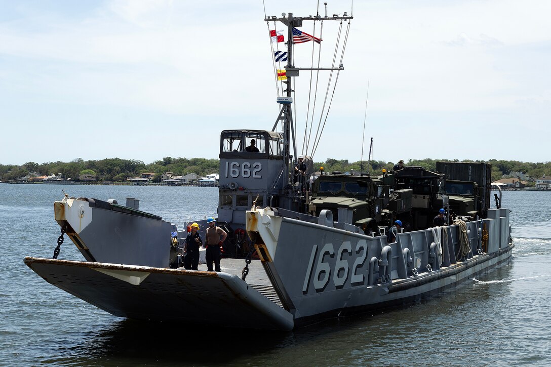 A landing craft utility approaches the sand ramp May 5, 2026, at Marine Corps Support Facility Blount Island in Jacksonville, Florida, enabling ship-to-shore operations for the 22nd Marine Expeditionary Unit (Special Operations Capable). The movement supported rapid equipment transfer to sustain operations in the U.S. Southern Command area of responsibility. (U.S. Marine Corps photo by Dustin Senger)