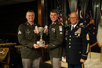 Indiana National Guard Sgt. Brendan Bartlett, a cyber specialist with the 147th Cyber Warfare Company, and Spc. Caleb Chambers, assigned to 1st Battalion, 151st Infantry Regiment, pose with their award for winning the highest overall combined score alongside Command Sgt. Maj. Mathew Hopkins, Michigan Army National Guard senior enlisted leader, after completing the Region IV Best Warrior Competition at Fort Custer Training Center, Michigan, May 2, 2026.