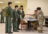 U.S. Air Force Airmen assigned to the 31st Air Expeditionary Wing in-process Republic of Korea air force pilots during exercise Freedom Flag 26-1 at Gwangju Air Base, Republic of Korea, April 14, 2026. The 31st Air Task Force, operating as the 31st AEW during FF 26-1, fields operation-ready forces capable of rapidly receiving, staging, integrating, and employing joint and combined forces. (U.S. Air Force photo by 2nd Lt. Daniel White)