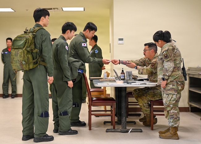 U.S. Air Force Airmen assigned to the 31st Air Expeditionary Wing in-process Republic of Korea air force pilots during exercise Freedom Flag 26-1 at Gwangju Air Base, Republic of Korea, April 14, 2026. The 31st Air Task Force, operating as the 31st AEW during FF 26-1, fields operation-ready forces capable of rapidly receiving, staging, integrating, and employing joint and combined forces. (U.S. Air Force photo by 2nd Lt. Daniel White)
