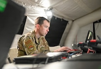 A U.S. Air Force Airman assigned to the 51st Combat Communications Squadron manages communication networks inside an expeditionary wing operations center during exercise Freedom Flag 26-1 at Gwangju Air Base, Republic of Korea, April 21, 2026. The exercise showcased the 31st AEW’s operational C2 capabilities, demonstrating seamless integration of joint and combined forces under a unified command structure. (U.S. Air Force photo by 2nd Lt. Daniel White)