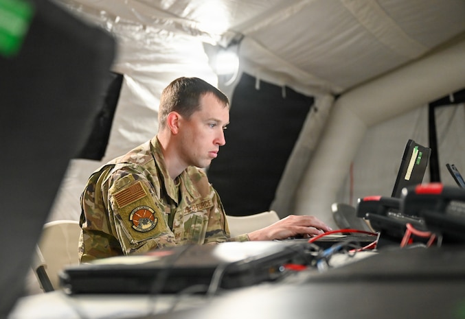 A U.S. Air Force Airman assigned to the 51st Combat Communications Squadron manages communication networks inside an expeditionary wing operations center during exercise Freedom Flag 26-1 at Gwangju Air Base, Republic of Korea, April 21, 2026. The exercise showcased the 31st AEW’s operational C2 capabilities, demonstrating seamless integration of joint and combined forces under a unified command structure. (U.S. Air Force photo by 2nd Lt. Daniel White)