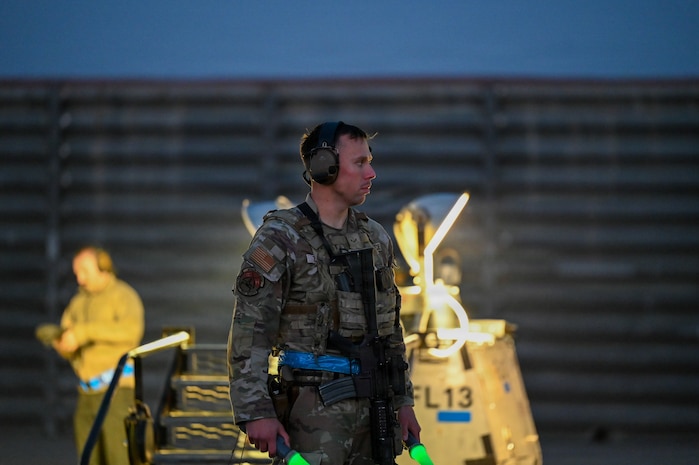 A U.S. Air Force Airman assigned to the 31st Combat Air Base Squadron prepares to marshal aircraft for night flying operations during exercise Freedom Flag 26-1 at Gwangju Air Base, Republic of Korea, April 20, 2026. Together, the 31st AEW and 31st CABS prepare Mission Ready Airmen capable of executing a variety of roles in dynamic environments. (U.S. Air Force photo by 2nd Lt. Daniel White)