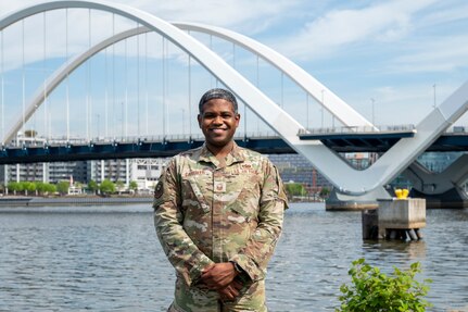 U.S. Air Force Master Sgt. Kymon G. Carriker, development advisor with the 11th Force Support Squadron and 811th Force Support Squadron, smiles in front of the waterfront at Joint Base Anacostia-Bolling, Washington, D.C., April 9, 2026. In addition to the role of development advisor to Airmen, he has coordinated and taught courses for Goose University, a professional development program at JBAB. (U.S. Air Force photo by Senior Airman Shanel Toussaint)