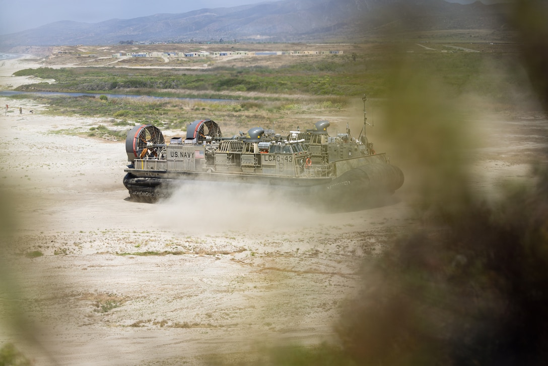 U.S. Navy Sailors assigned to Beach Master Unit 1, Naval Beach Group 1, pilot a landing craft, air cushion during a field exercise with U.S. Marines from 1st Maintenance Battalion, 1st Combat Readiness Regiment, 1st Marine Logistics Group, on Marine Corps Base Camp Pendleton, California, May 1, 2026. The FEX focused on rehearsing maintenance operations and preparing Marines and Sailors to execute LCAC operations in an expeditionary environment. (U.S. Marine Corps photo by Sgt. Mary Torres)