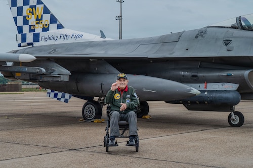 Retired Col. Joseph Peterburs poses in front of an F-16 aircraft from a unit he previously served with during the Gathering of Eagles and National Security Forum event at Maxwell Air Force Base, Alabama, May 6, 2026.