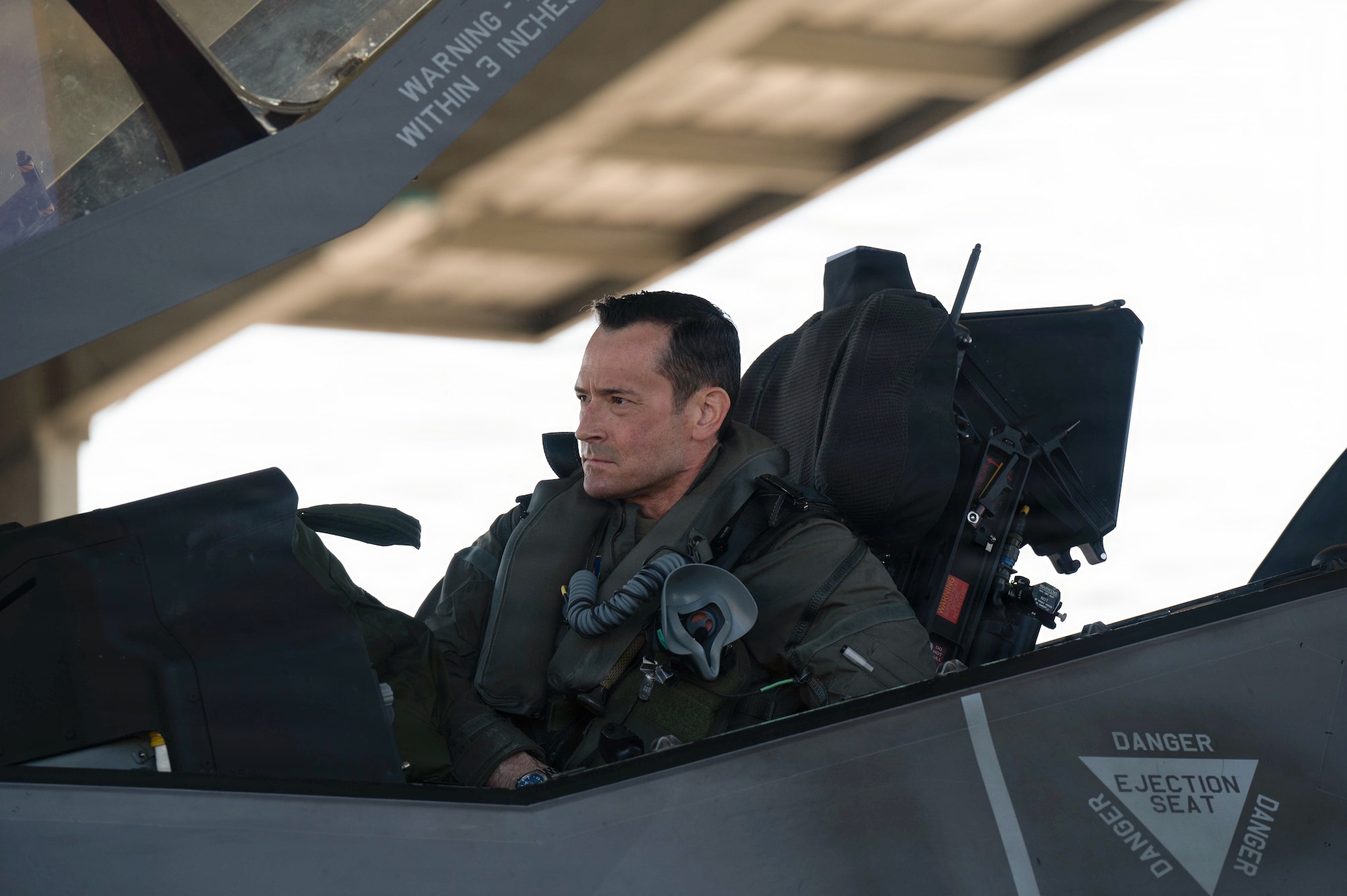 A pilot conducts pre-flight checks in an F35A Lightning II aircraft.
