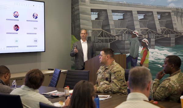 Picture of a man giving a brief to several people.