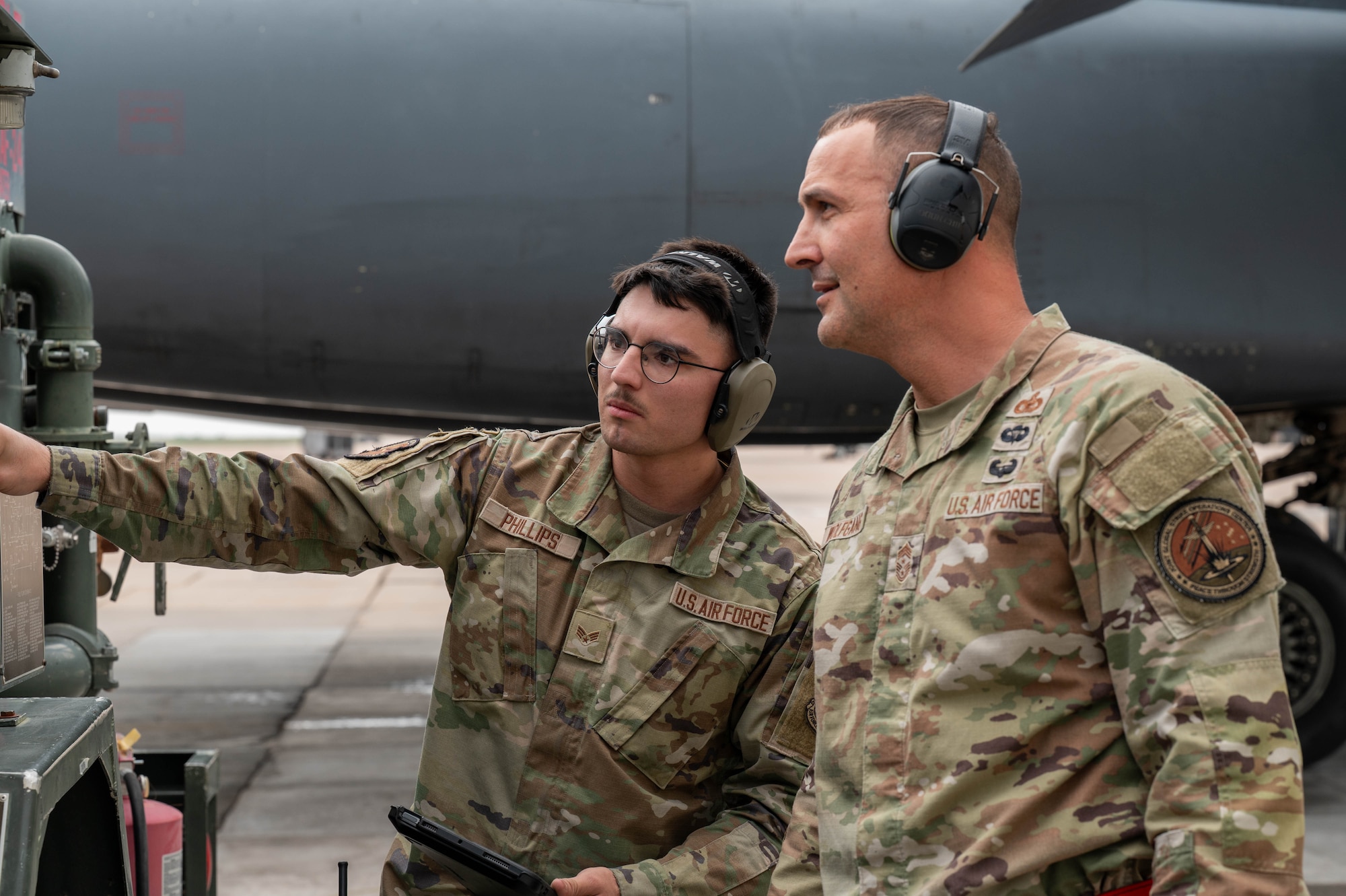 U.S. Air Force Senior Airman Random Phillips, 7th Logistics Readiness Squadron fuels distribution operator, left, discusses fuel systems with Chief Master Sgt. Brandon Wolfgang, Eighth Air Force command chief and Joint-Global Strike Operations Center senior enlisted leader, at Dyess Air Force Base, Texas, May 5, 2026. The interaction allowed Wolfgang to hear directly from frontline Airmen about the technical capabilities and challenges involved in sustaining flightline operations for the B-1B Lancer fleet. (U.S. Air Force photo by Airman 1st Class William Neal)