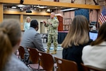 A military officer talks to audience members.