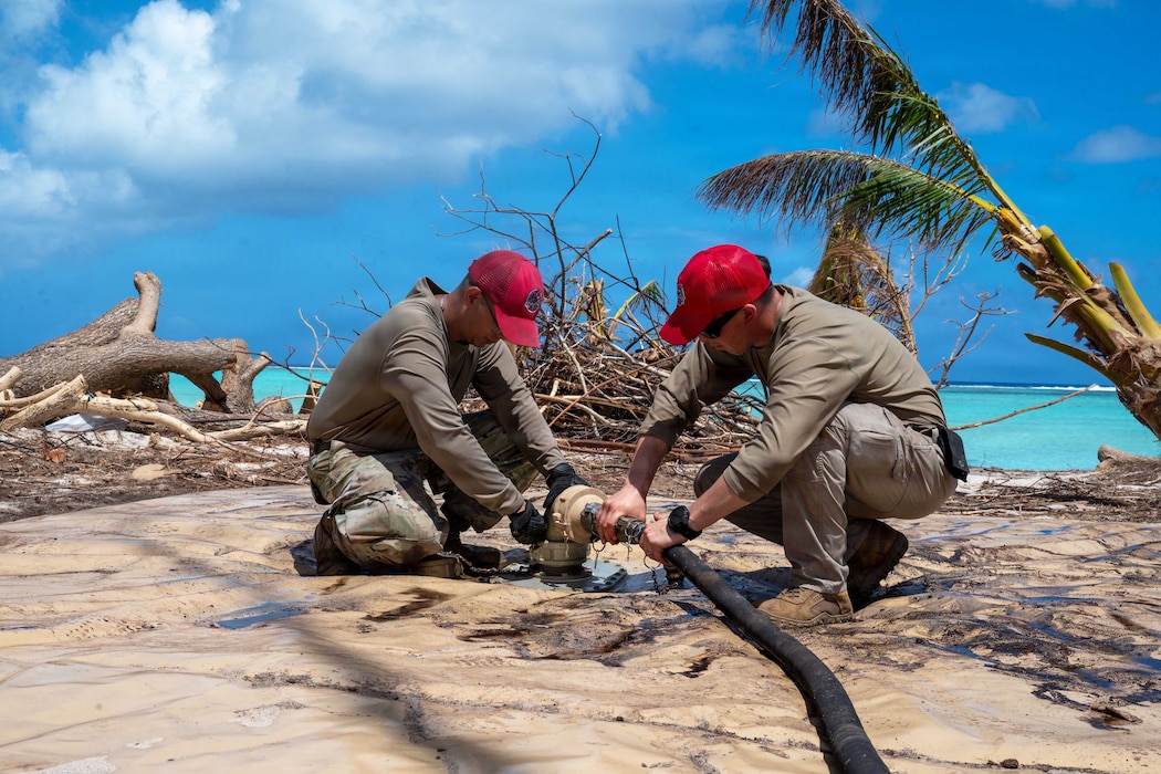 554th RED HORSE Squadron connects a hose to a Reverse Osmosis Water Purification Unit