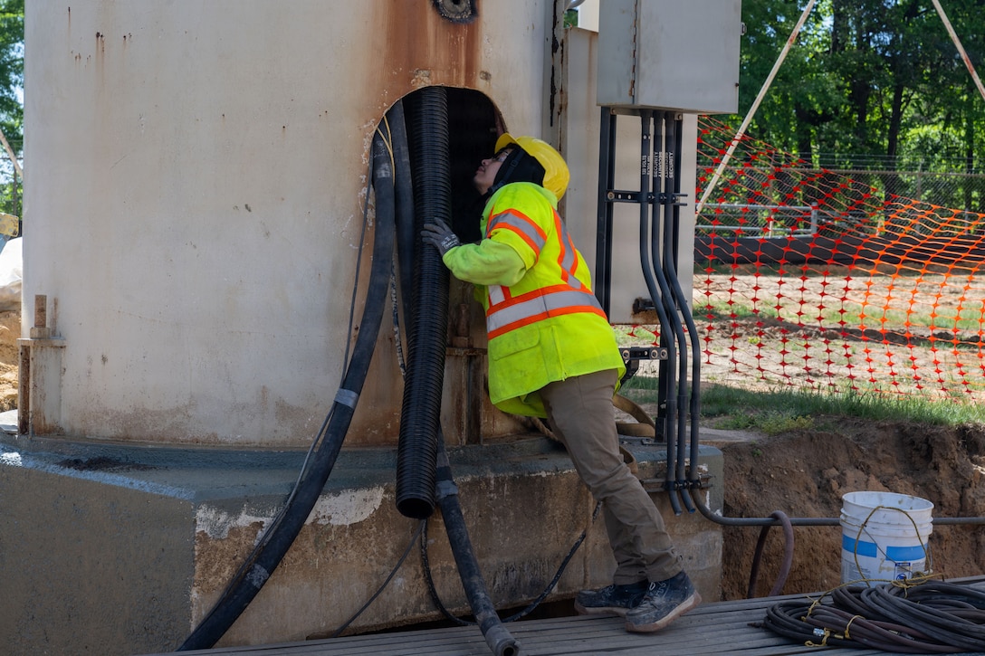 Eddie Jacob, construction worker, checks the interior piping of the water tower.