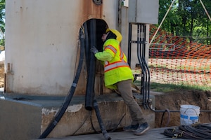 Eddie Jacob, construction worker, checks the interior piping of the water tower.