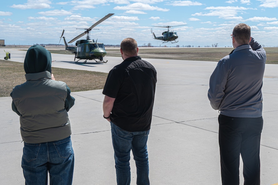Members of the Community Leadership Institute (CLI) watch a UH-1N Iroquois take off from Minot Air Force Base, North Dakota, April 30, 2026. The CLI is an eight-week program designed to showcase to its members everything Minot has to offer. (U.S. Air Force photo by Airman Ben Selchow)