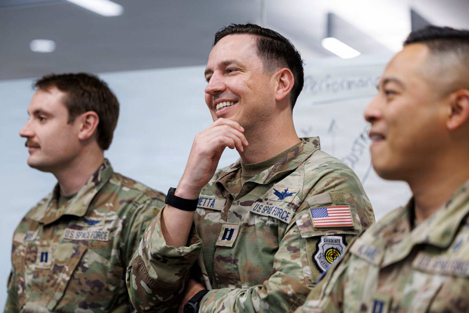 Three service members stand side-by-side.
