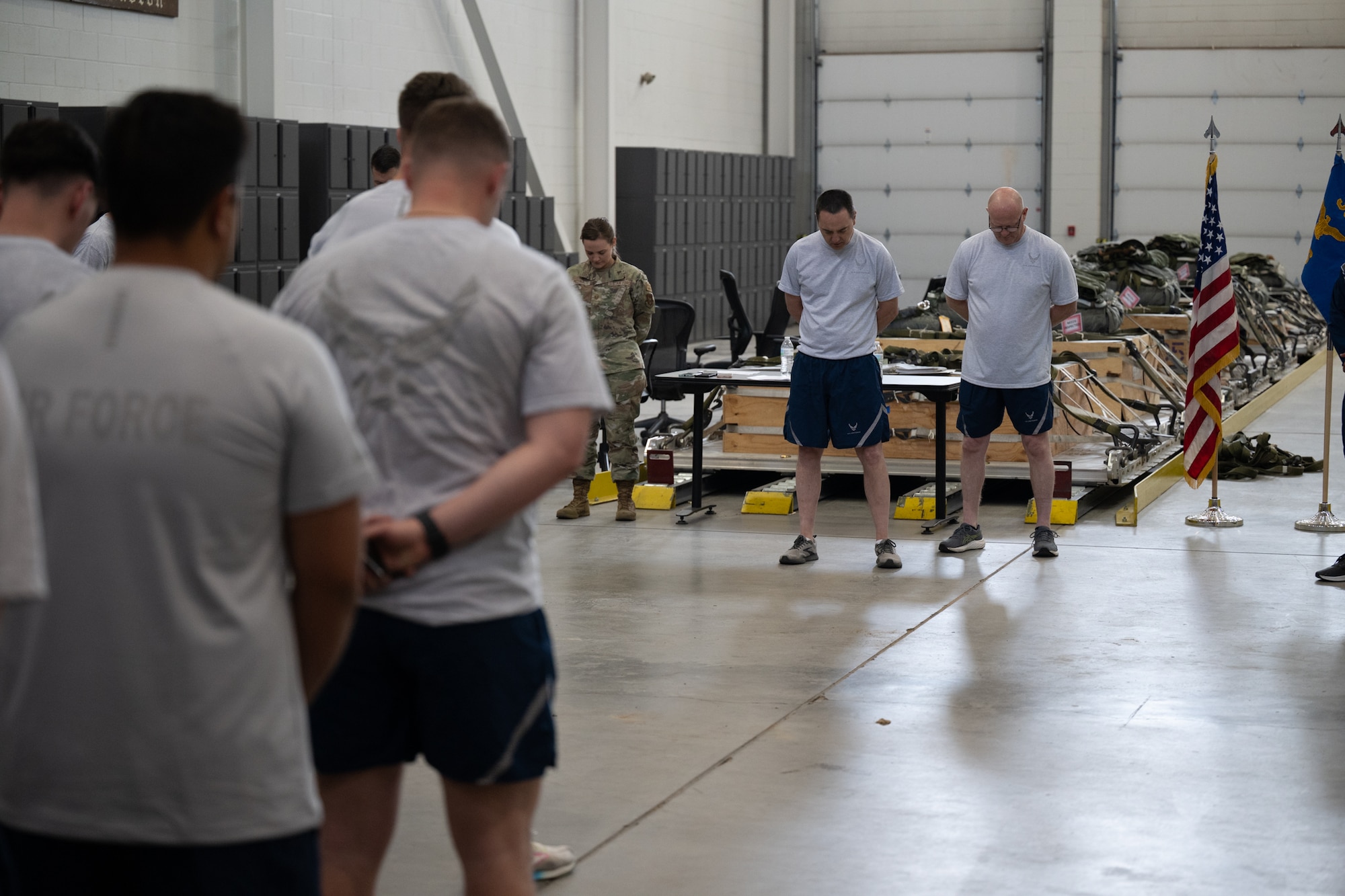 Airmen bow their heads for a moment of silence.