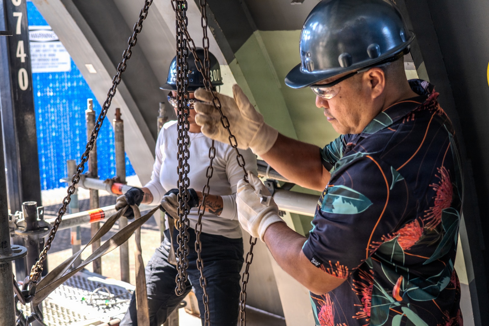 Ronald Gorgonio, a production controller and participant with EDP Cadre A 2026 at Pearl Harbor Naval Shipyard and Intermediate Maintenance Facility lowers a pipe using a chain-fall during a training exercise at the Learning Center on March 24, 2026.