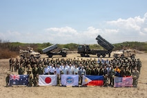 Gilberto C. Teodoro Jr., Secretary of National Defense of the Philippines, and Shinjiro Koizumi, Minister of Defense of Japan, pose for a group photo with U.S. Marines assigned to 3rd Marine Littoral Regiment, 3rd Marine Division, Soldiers with 7th Infantry Division, Multi-Domain Command - Pacific, Philippine marines with 4th Marine Brigade, Japan Ground Self-Defense Force soldiers with 1st Artillery Brigade, an Australian soldier with 5th/7th Battalion, Royal Australian Regiment, and other civilian attendees following a joint task force maritime strike event during Exercise Balikatan 2026 at Paoay Sand Dunes, Philippines, May 6, 2026.