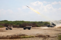 A Japan Ground Self-Defense Force Type 88 Surface-to-Ship Missile System assigned to 1st Artillery Brigade, fires while positioned next to a Navy-Marine Expeditionary Ship Interdiction System and Marine Air-Defense Integrated System, both with 3rd Marine Littoral Regiment, 3rd Marine Division, at a joint task force maritime strike event during Exercise Balikatan 2026 at Paoay Sand Dunes, Philippines, May 6, 2026.