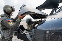 Philippine Air Force Sgt. Julius Chun Manasan, left, mechanic assigned to the 205th Tactical Helicopter Wing, and U.S. Army 1st Sgt. Christopher Pacheco, right, senior mechanic and standardization instructor assigned to the Hawaii Army National Guard, conduct preflight checks on a Philippine Air Force S-70i Black Hawk helicopter during a Rotary Wing Subject Matter Expert Exchange Clark Air Base, Philippines, April 15, 2026.