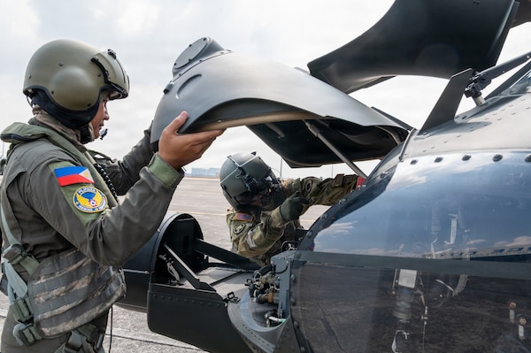 Philippine Air Force Sgt. Julius Chun Manasan, left, mechanic assigned to the 205th Tactical Helicopter Wing, and U.S. Army 1st Sgt. Christopher Pacheco, right, senior mechanic and standardization instructor assigned to the Hawaii Army National Guard, conduct preflight checks on a Philippine Air Force S-70i Black Hawk helicopter during a Rotary Wing Subject Matter Expert Exchange Clark Air Base, Philippines, April 15, 2026.