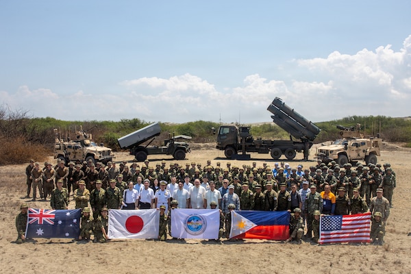 Gilberto C. Teodoro Jr., Secretary of National Defense of the Philippines, and Shinjiro Koizumi, Minister of Defense of Japan, pose for a group photo with U.S. Marines assigned to 3rd Marine Littoral Regiment, 3rd Marine Division, Soldiers with 7th Infantry Division, Multi-Domain Command - Pacific, Philippine marines with 4th Marine Brigade, Japan Ground Self-Defense Force soldiers with 1st Artillery Brigade, an Australian soldier with 5th/7th Battalion, Royal Australian Regiment, and other civilian attendees following a joint task force maritime strike event during Exercise Balikatan 2026 at Paoay Sand Dunes, Philippines, May 6, 2026.