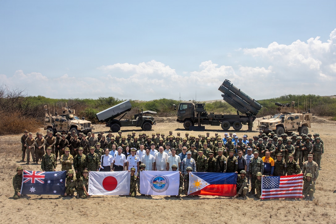 Gilberto C. Teodoro Jr., Secretary of National Defense of the Philippines, and Shinjiro Koizumi, Minister of Defense of Japan, pose for a group photo with U.S. Marines assigned to 3rd Marine Littoral Regiment, 3rd Marine Division, Soldiers with 7th Infantry Division, Multi-Domain Command - Pacific, Philippine marines with 4th Marine Brigade, Japan Ground Self-Defense Force soldiers with 1st Artillery Brigade, an Australian soldier with 5th/7th Battalion, Royal Australian Regiment, and other civilian attendees following a joint task force maritime strike event during Exercise Balikatan 2026 at Paoay Sand Dunes, Philippines, May 6, 2026.