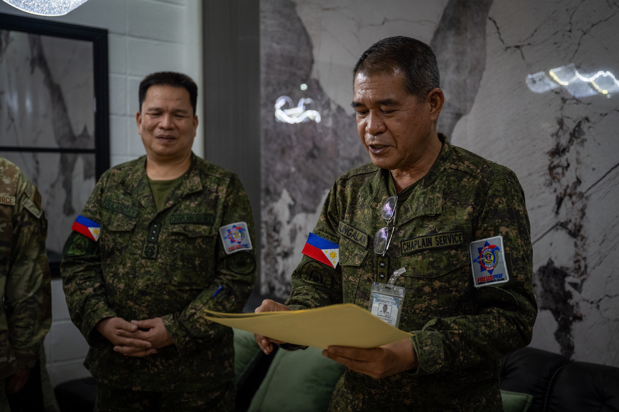 Philippine Air Force Lt. Col. Dennis Alingalan, Headquarters Service Support Group chief of chaplain services management, presents certificates of participation during a chaplain fellowship exchange at Clark Air Base, Philippines, April 22, 2026. The fellowship exchange provided opportunities for the PAF chaplain corps and 21st Air Expeditionary Wing to discuss the importance of spiritual fitness and reinforce ties between the organizations. (U.S. Air Force photo by Airman 1st Class Adrien Tran)