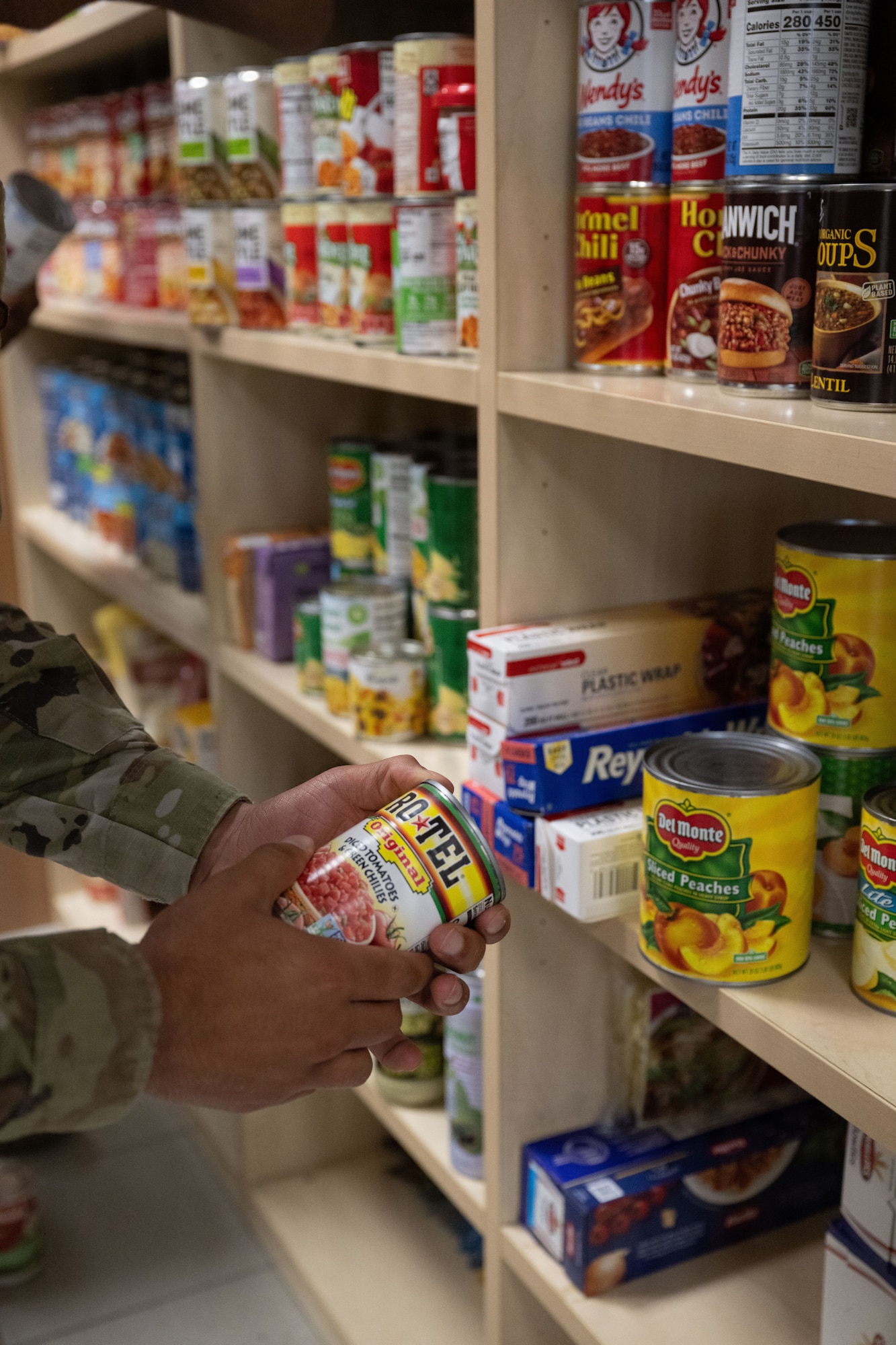 An Airman stocks a food pantry.