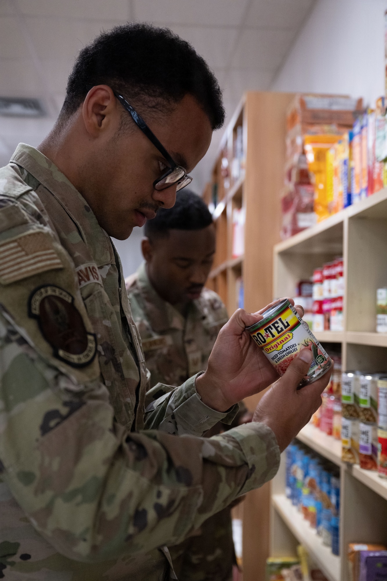 An Airman stocks a food pantry.
