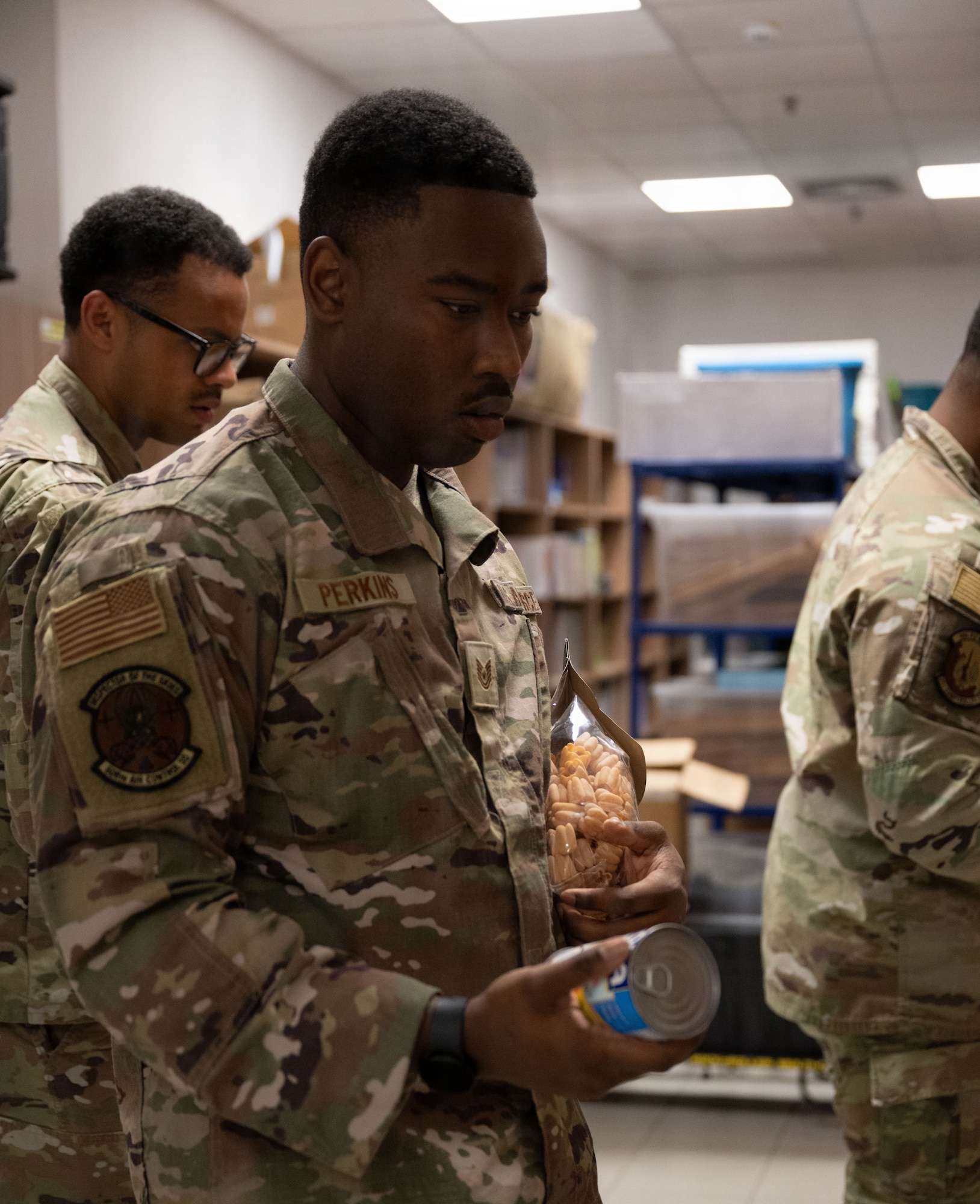 An Airman stocks the food pantry.