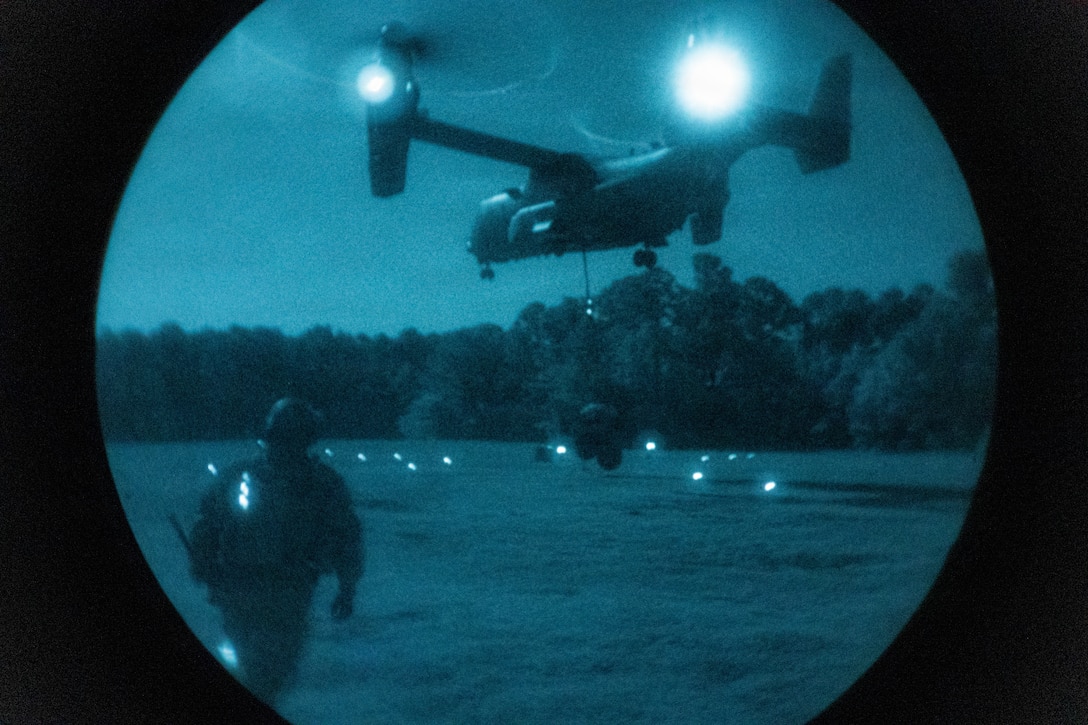 A U.S. Marine Corps MV-22B Osprey tiltrotor aircraft assigned to Marine Medium Tiltrotor Squadron (VMM) 365 (Reinforced), 24th Marine Expeditionary Unit, picks up an M101 trailer load during a helicopter support team sling load training on Marine Corps Base Camp Lejeune, North Carolina, April 29, 2026. The training focused on the technical execution of external lift procedures to transport heavy equipment, validating the team’s tactical proficiency and ensuring the unit remains ready to sustain forces in austere, expeditionary environments. (U.S. Marine Corps photo by Lance Cpl. Payton Walley)